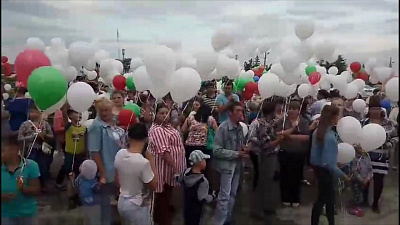 Сотни человек запустили белые шары на главной площади в Каслях 